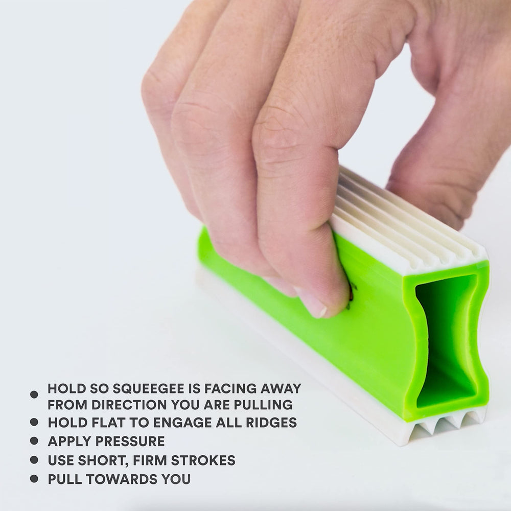FurDozer Green detailing tool in car interior for pet hair.