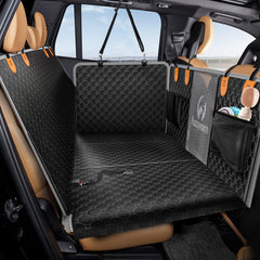 Fuzzyearn leather back seat extender installed with expanded space for dogs on trips.
