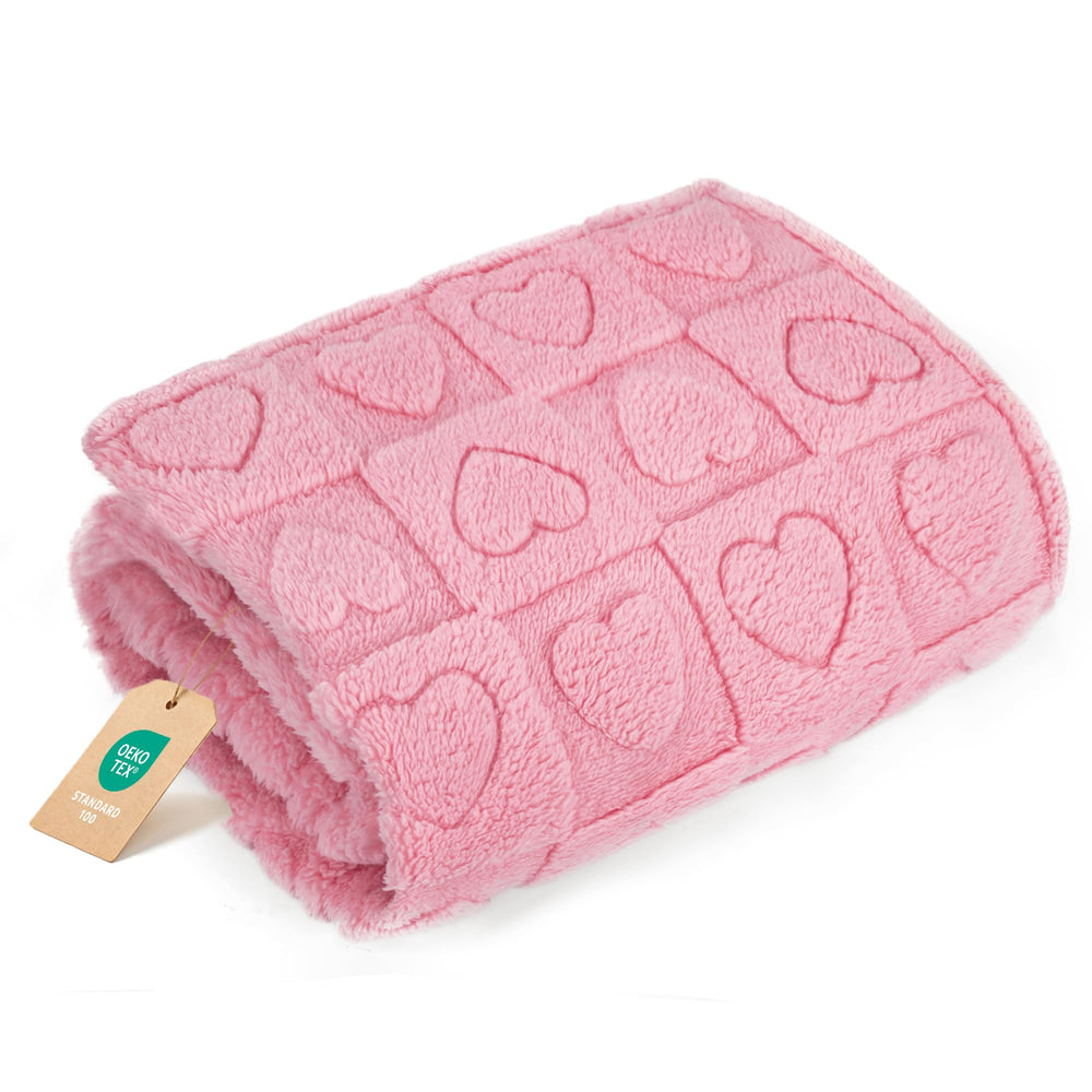 gogobunny calming-blanket-dog-pink-30x40-on-sofa offers cozy, stress-relieving comfort.