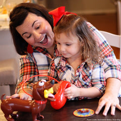 Goliath Doggie Doo leash-squeeze action demonstrates interactive play.