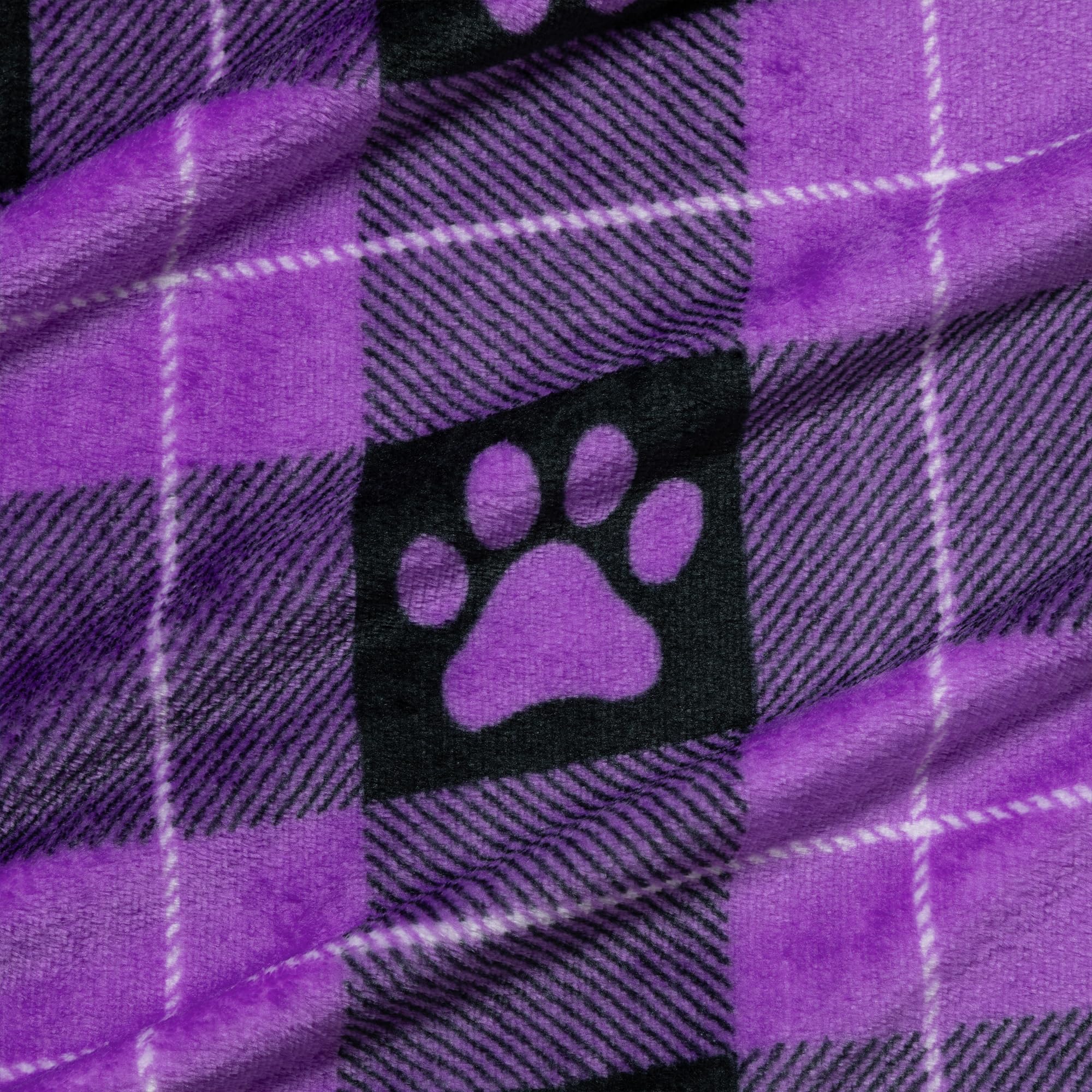 GreaterGood paw-print purple crate-use blanket creates a familiar, comforting space in a crate.