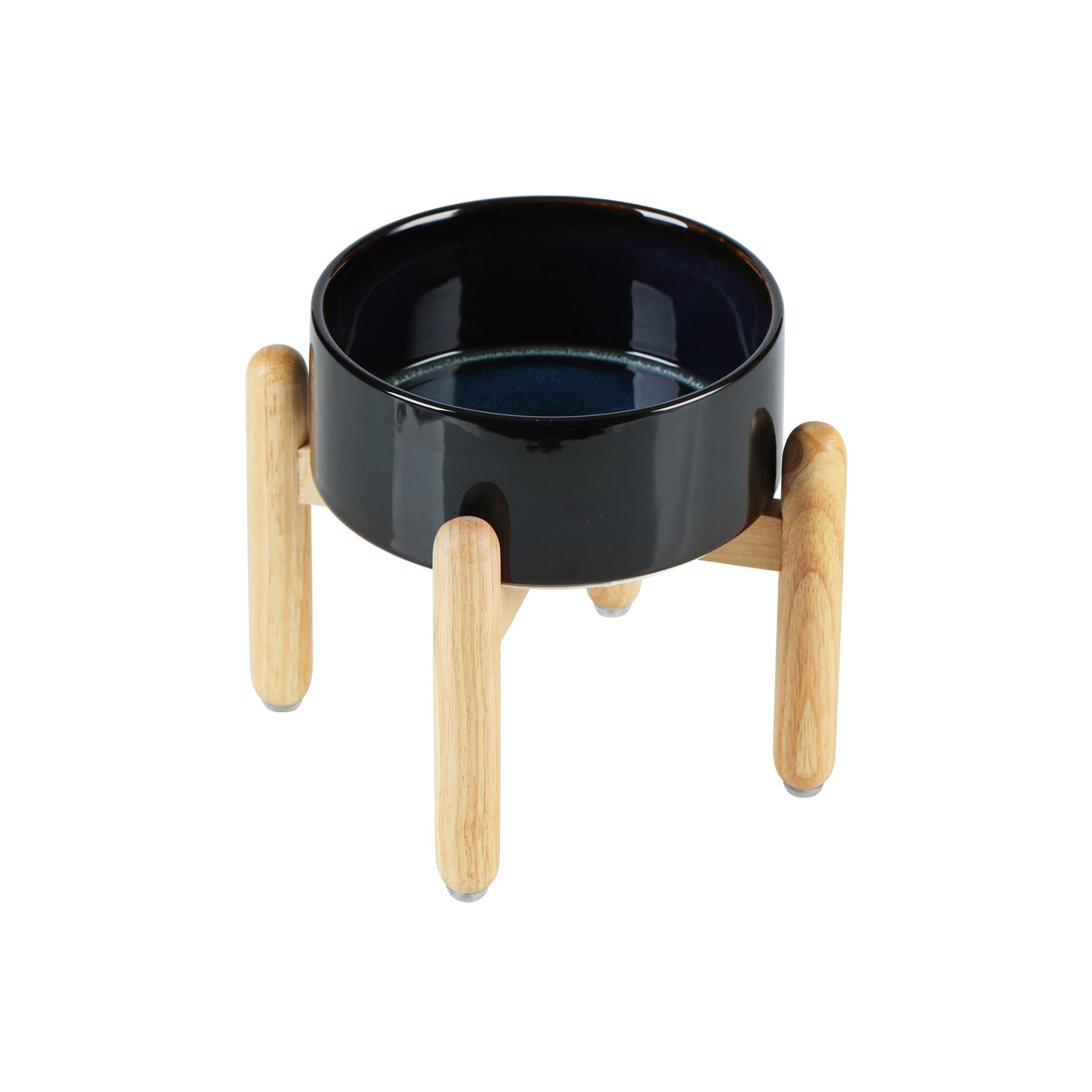 Havniva Starry Sky ceramic dog bowl on a wooden stand for elevated feeding.