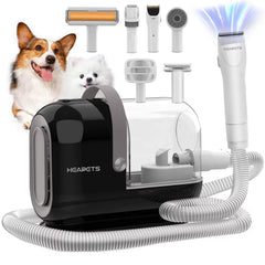 HEAPETS dog grooming vacuum kit in action capturing fur during a trimming session.