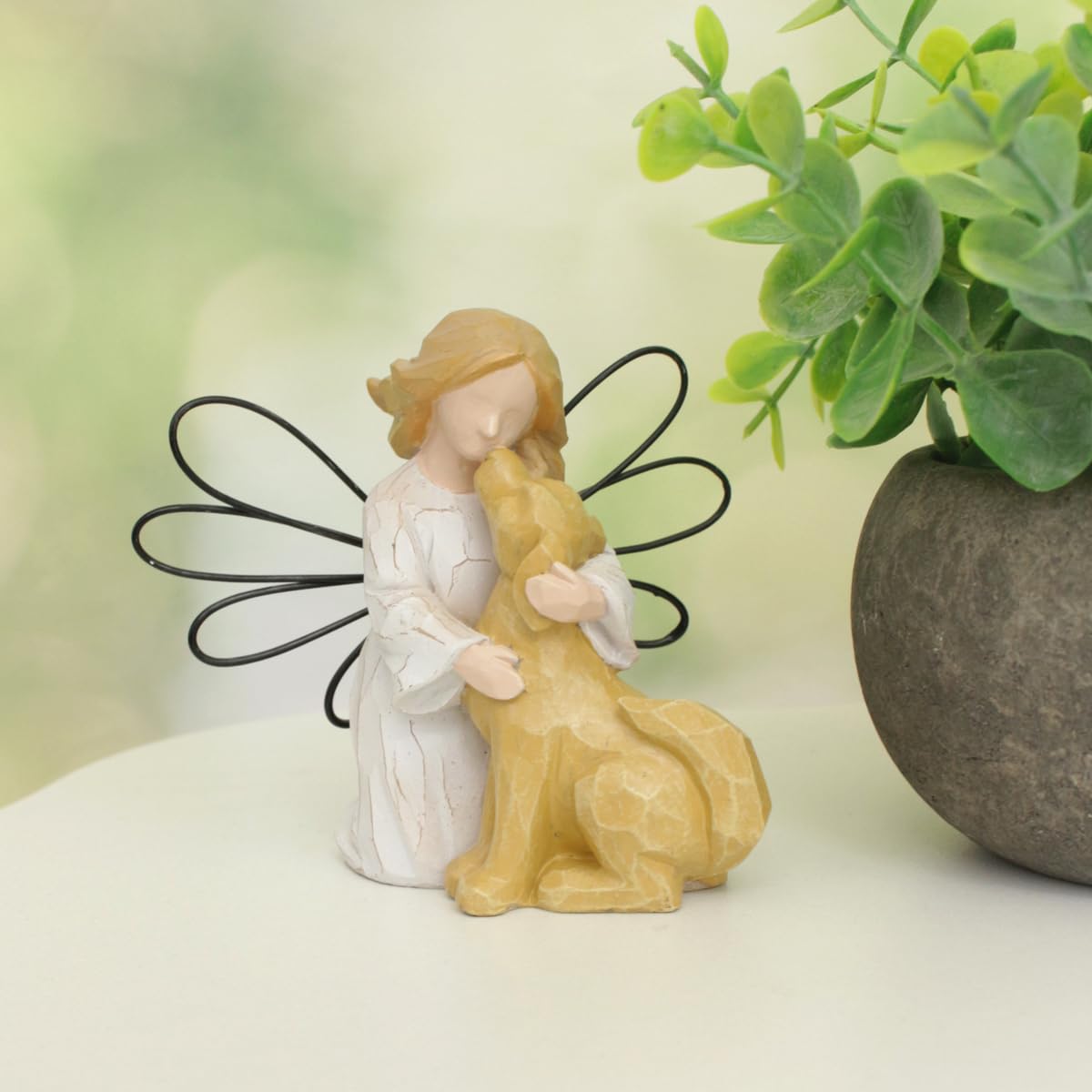 HEBYJO Angel Kissing Dog Statue in living room setting as memorial tribute