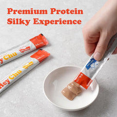 Hey Chu Squeezable Treats salmon tube close-up emphasizes creamy texture.