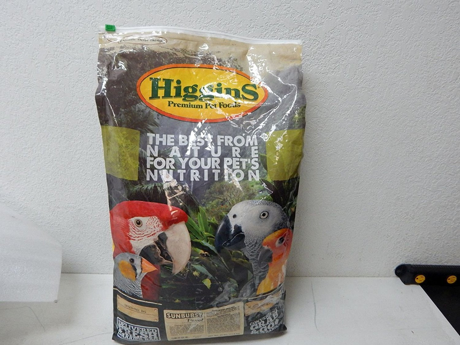 Higgins Sunburst Parrot Food 25lb bag shows balanced daily nutrition blend.