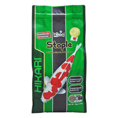 Hikari staple floating pellets for koi in a bowl, easy feeding monitoring.