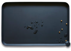 Hoki Found L silicone non-slip placemat front view showing spill containment.