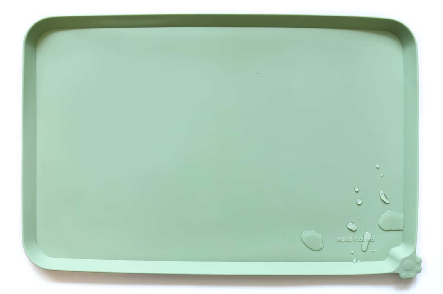 Hoki Found large silicone pet food mat closeup with raised edge for spill control.
