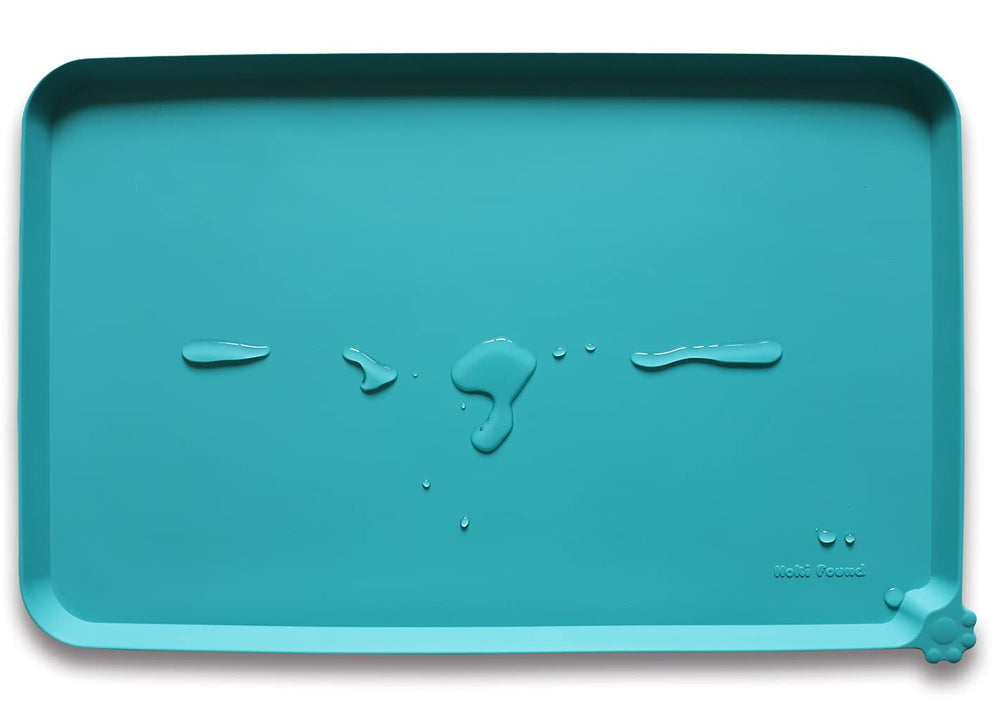 Hoki Found silicone non-slip pet feeding mat teal closeup shows easy-clean, spill-preventing surface.