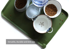 Hoki Found dark olive mat under bowls protects carpet from spills.