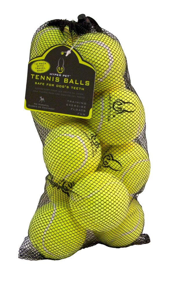 Hyper Pet tennis ball pink on grass for easy spotting during playtime.