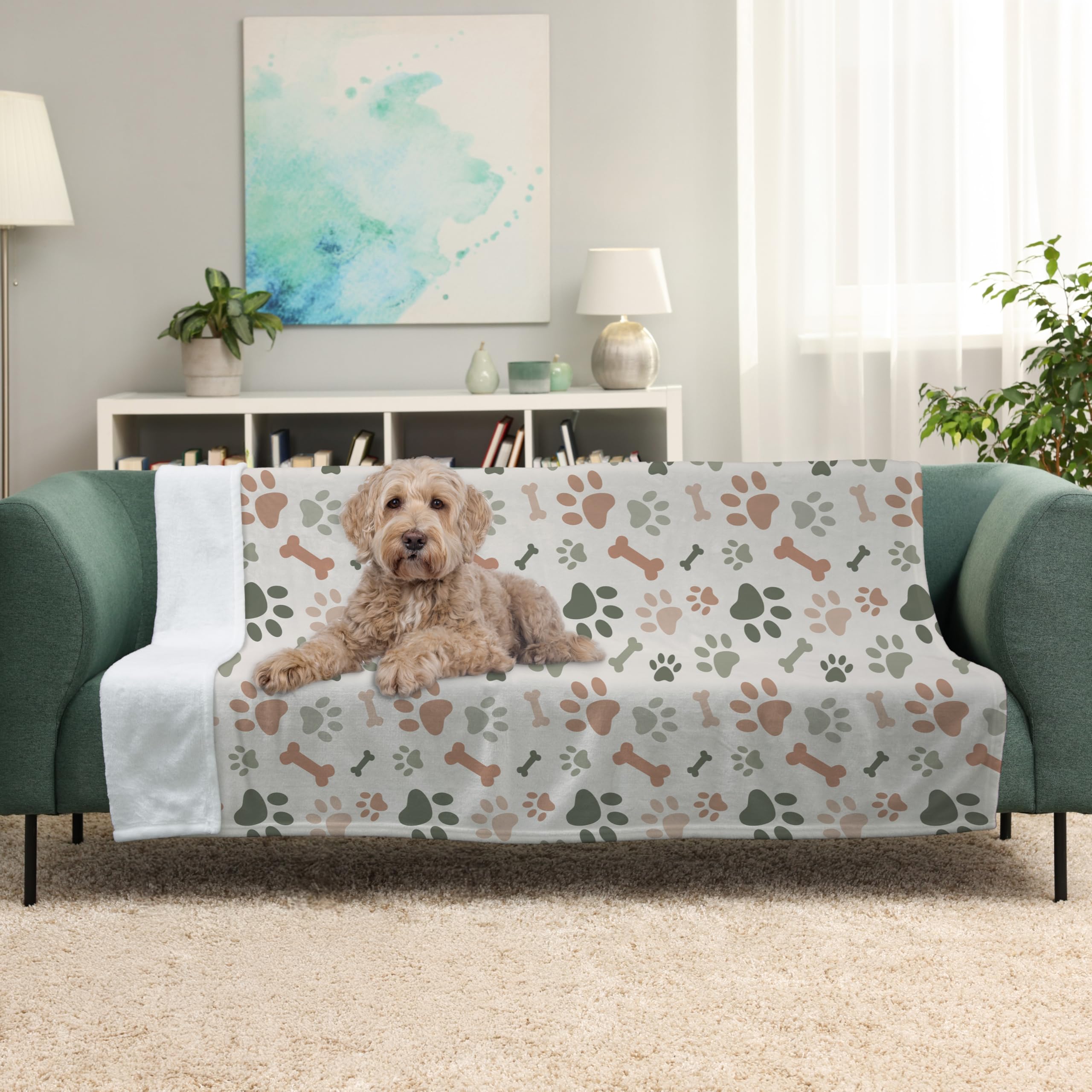 Karisma Decor paw print blanket draped on sofa to protect furniture from pet hair.