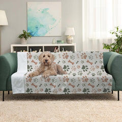 Karisma Decor paw print blanket draped on sofa to protect furniture from pet hair.