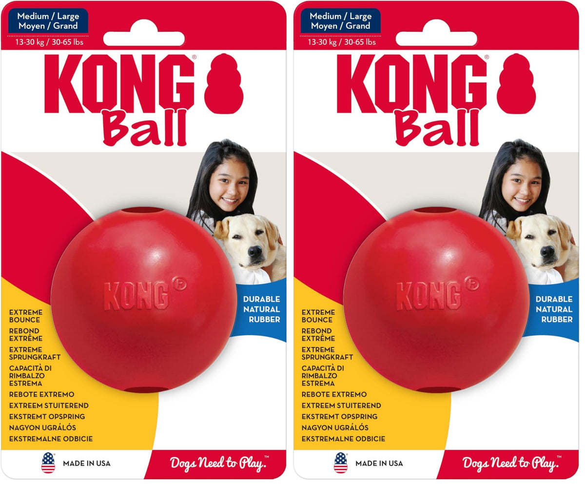 KONG Ball with Hole red fetch toy in grass for training and play.