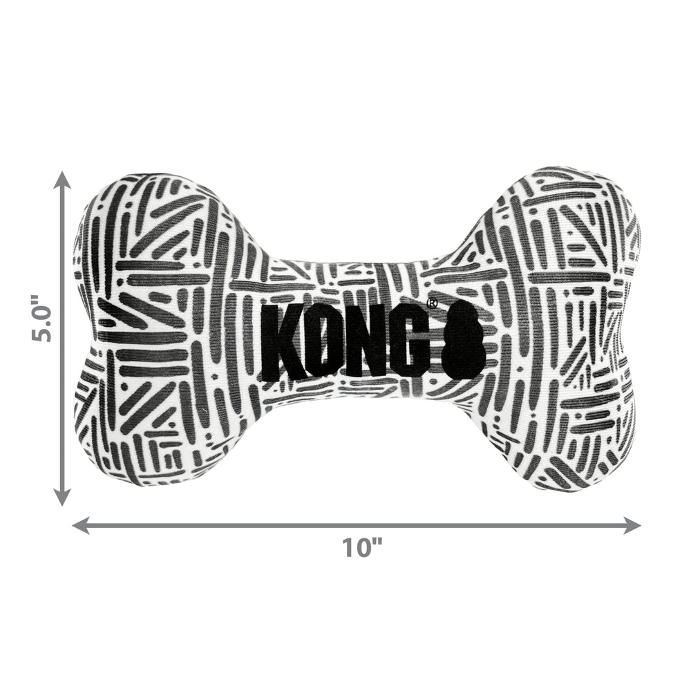 KONG Maxx Bone Sm/Md indoor-outdoor play mood shot emphasizing versatile use.