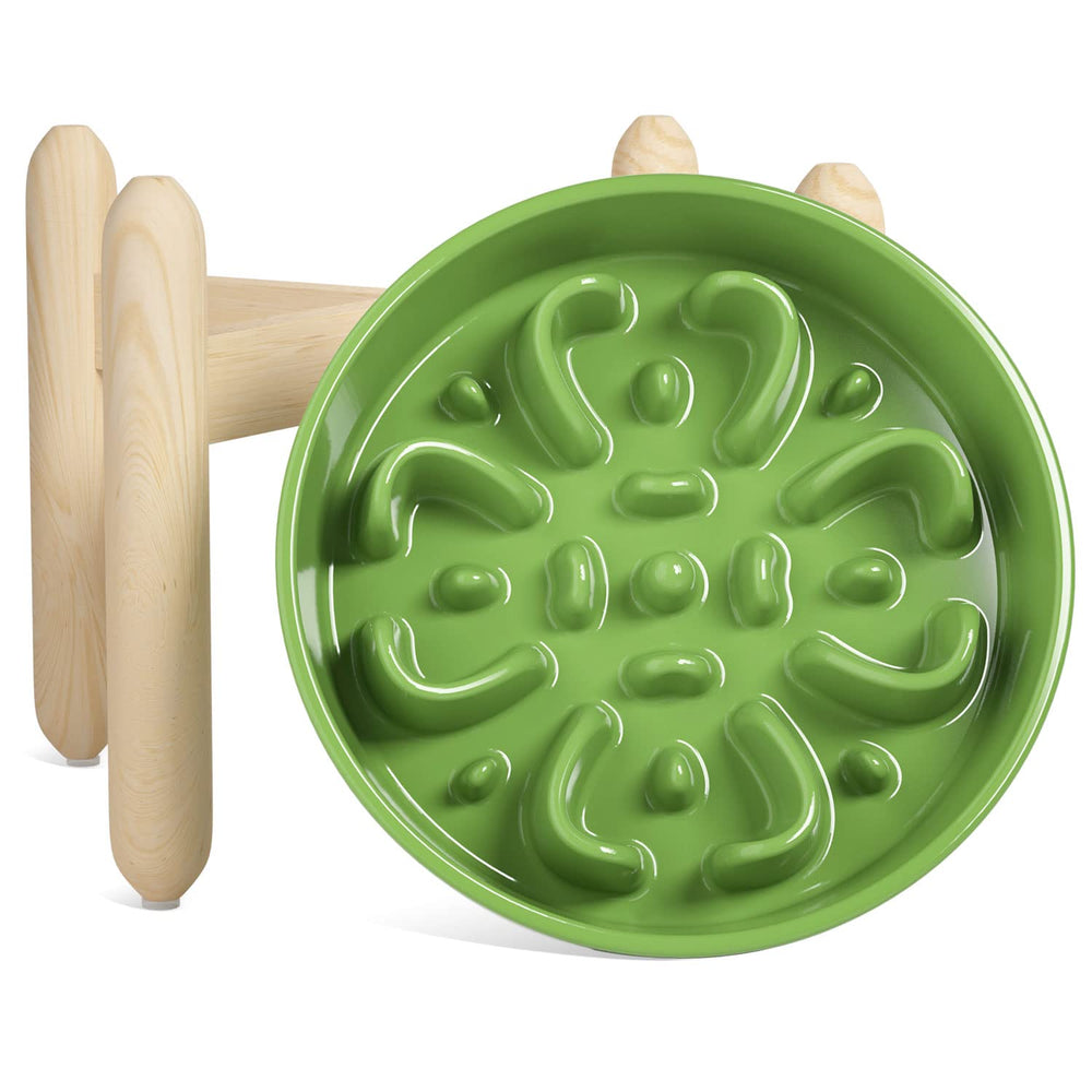 LE TAUCI ceramic slow feeder bowl on a wooden stand promotes paced meals.
