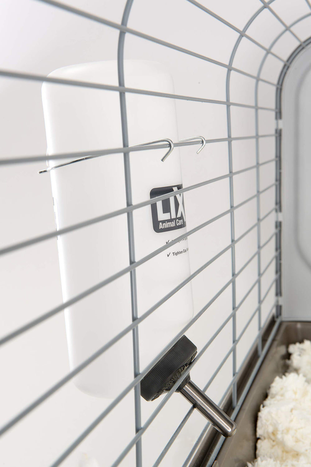 Lixit quick-release spring bottle holder shown for simple enclosure setup.