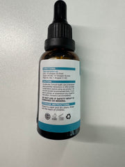 MaxHemp pet oil dropper on a cat during grooming for smoother handling.