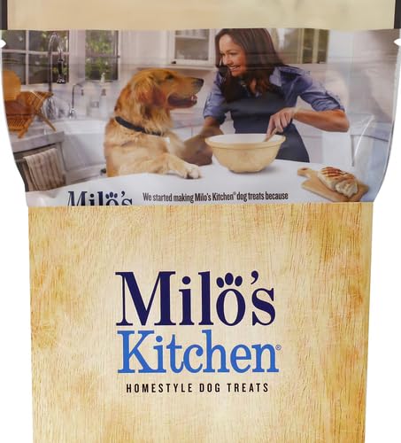 Milo's Kitchen Simply Chicken Jerky on paw: chewy, bite-sized reward.