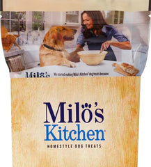 Milo's Kitchen Simply Chicken Jerky on paw: chewy, bite-sized reward.