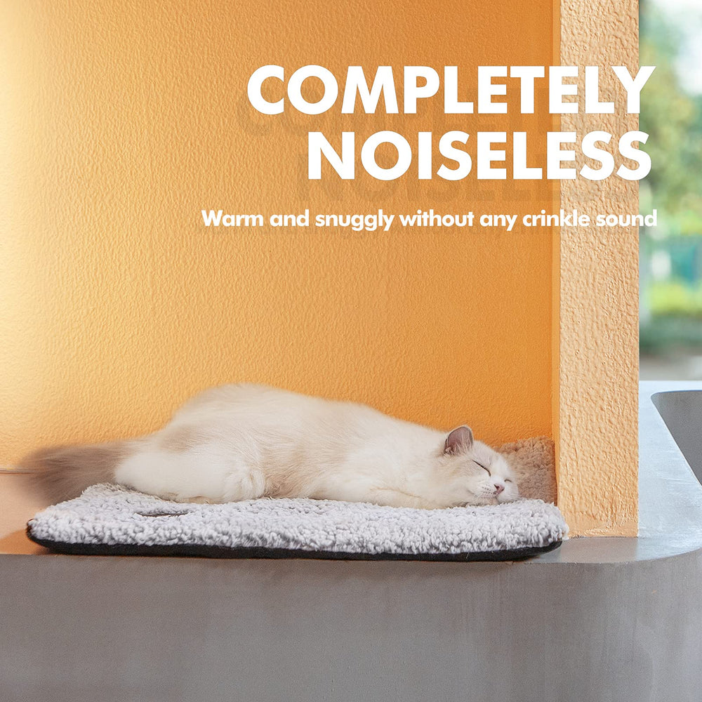 Mora Pets self-warming bed on sofa ready for cozy naps.