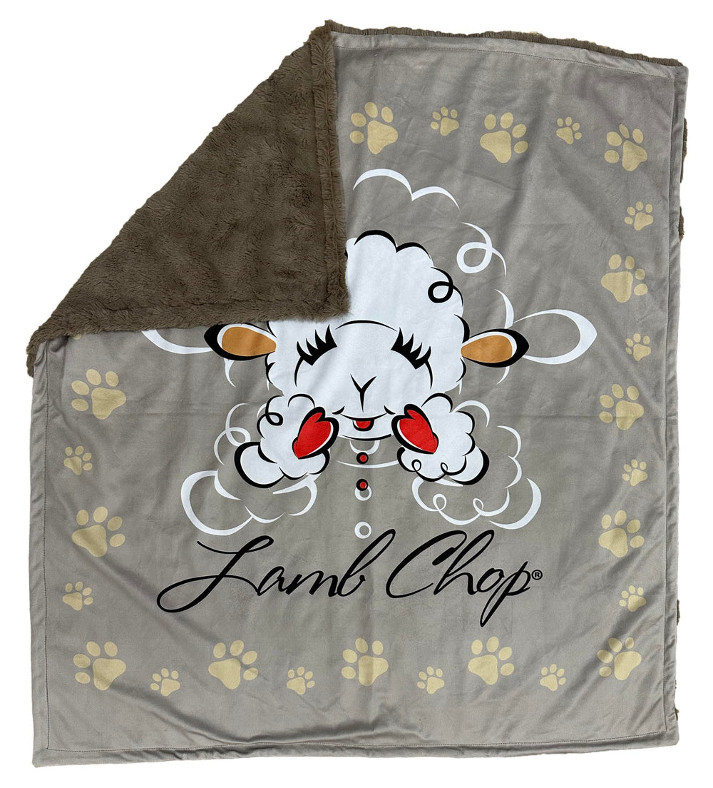 Multipet Lamb Chop Blanket laid beside a dog for cozy snuggle sessions.