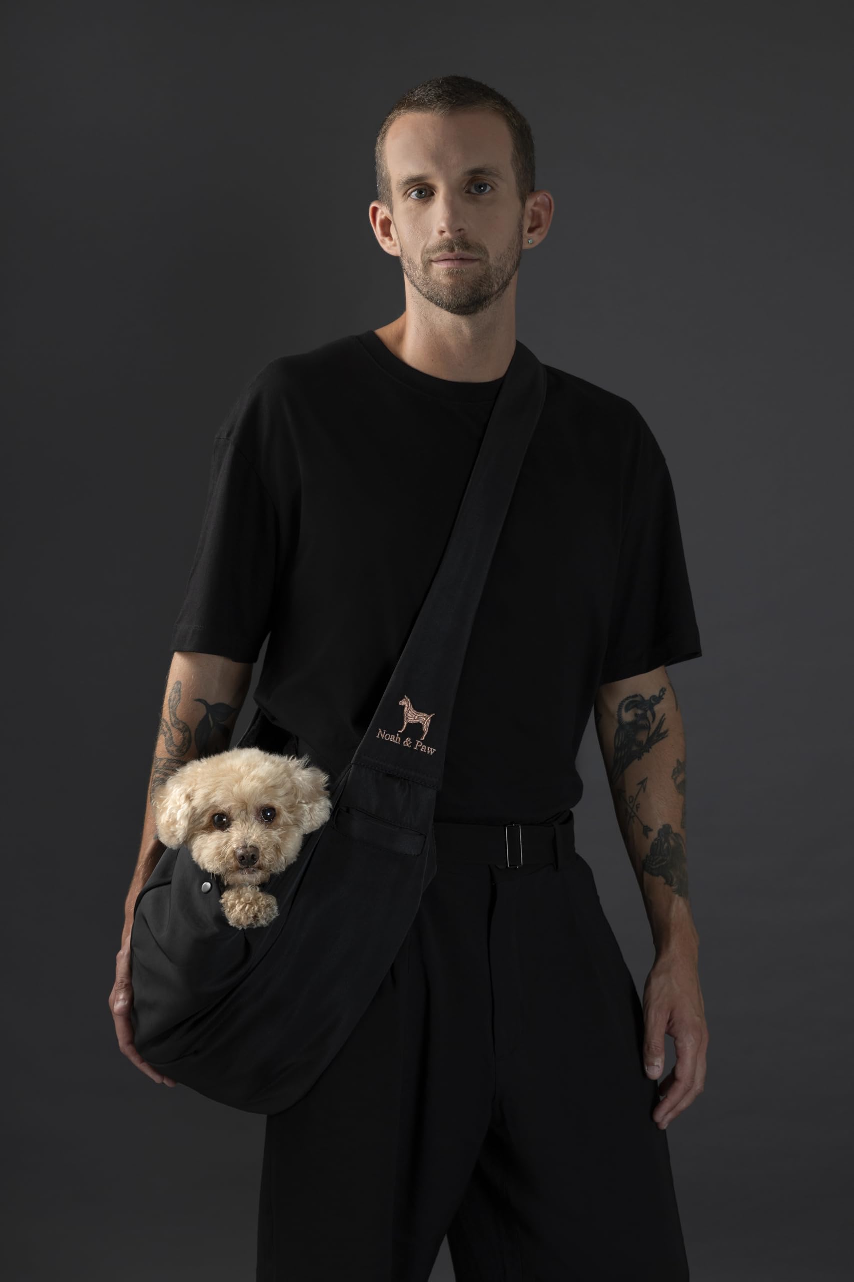 Noah & Paw dog sling carrier side view shows adjustable strap for custom fit.