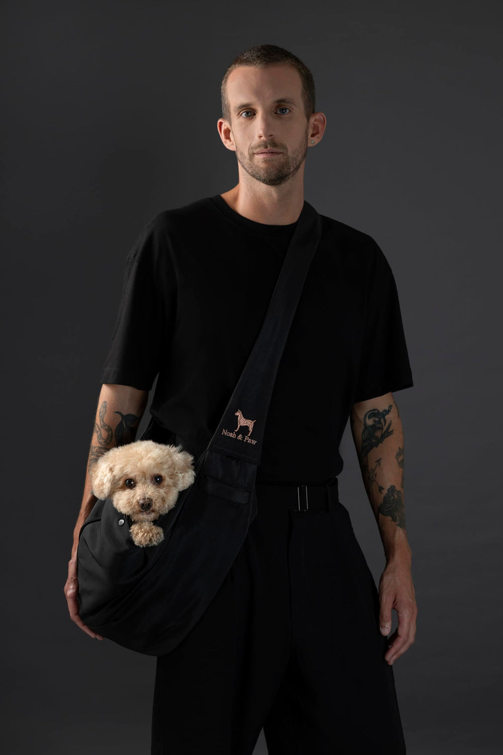 Noah & Paw dog sling carrier side view shows adjustable strap for custom fit.