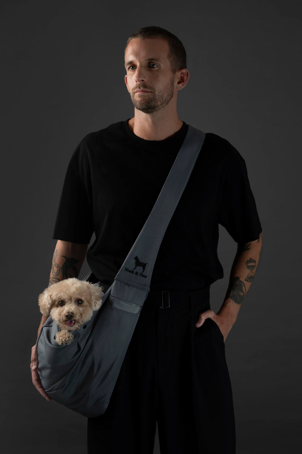 Noah & Paw dog sling carrier adjustable strap close-up for customized fit during long walks.