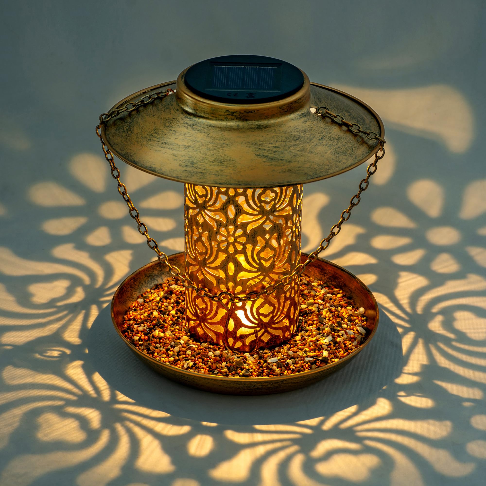 Ottsuls solar bird feeder lantern-night light demonstrates ambient glow for garden wildlife at dusk.