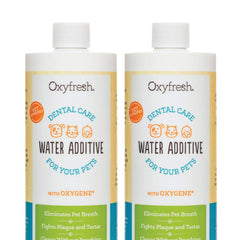 Oxyfresh Premium Pet Dental Care Solution bottle being poured into a dog's water bowl for fresh breath.
