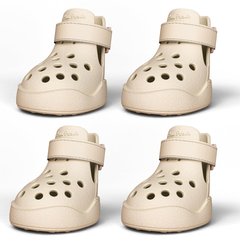 PawPosh dog shoes beige non-slip waterproof on pavement for secure outdoor walking.
