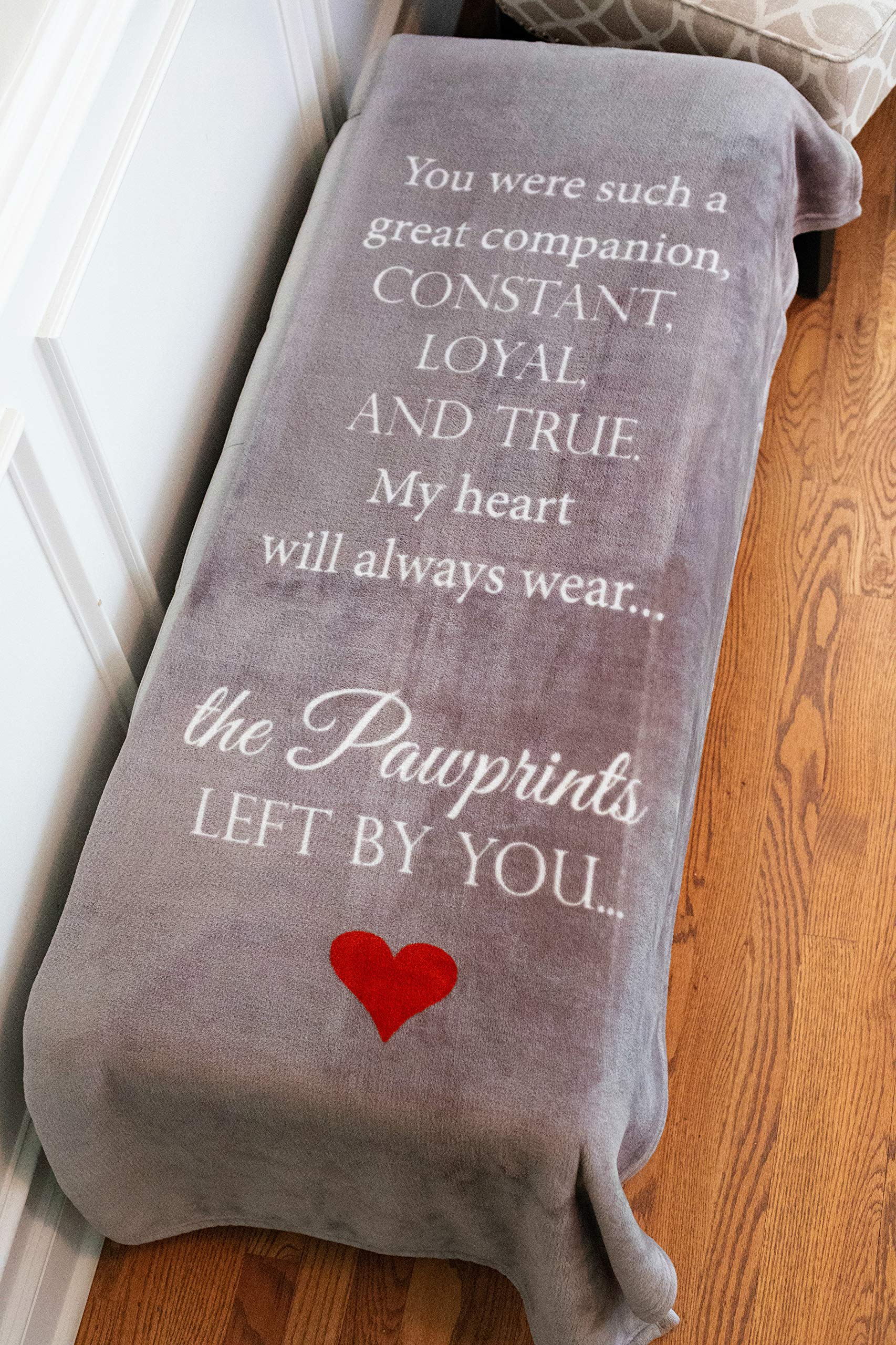 Pawprints Left By You memorial blanket draped on a couch for cozy remembrance