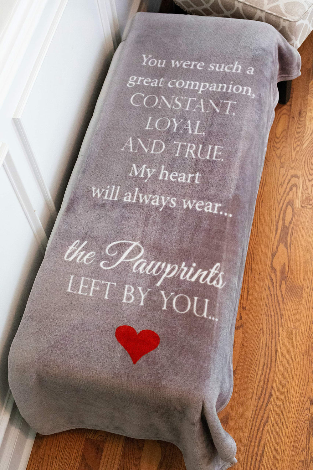 Pawprints Left By You memorial blanket draped on a couch for cozy remembrance