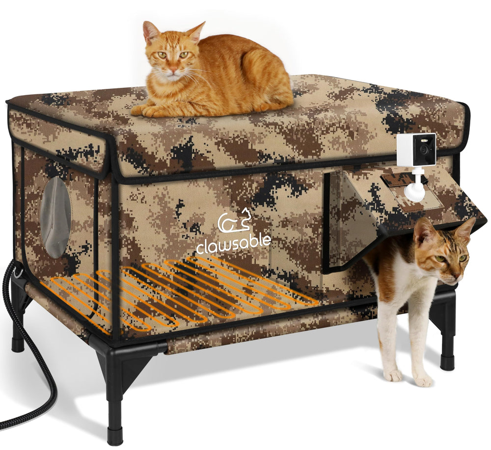 Rolimate indestructible heated cat house with desert camouflage and monitoring camera.