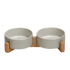 SPUNKYJUNKY ceramic dog bowl with wood stand reduces spills during meals.