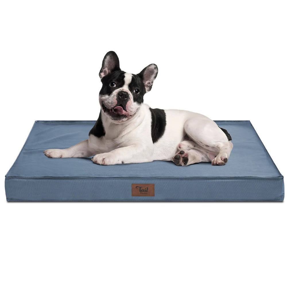 Tail Stories Outdoor Dog Bed blue resting inside a crate for joint-supporting comfort.
