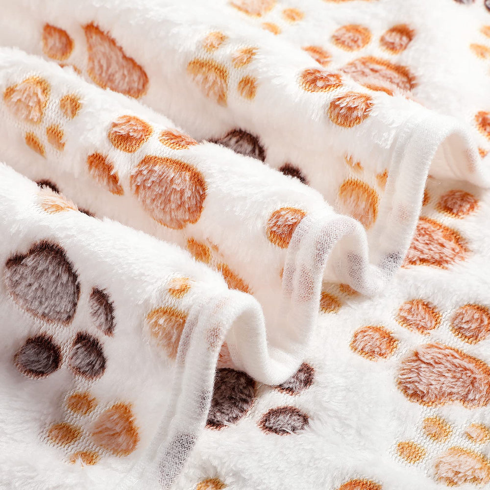 Tegeme paw-print blanket is machine washable for easy care.