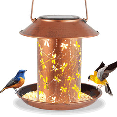 Tepaken dragonfly lantern bird feeder on ground with warm dragonfly projection for garden ambience.