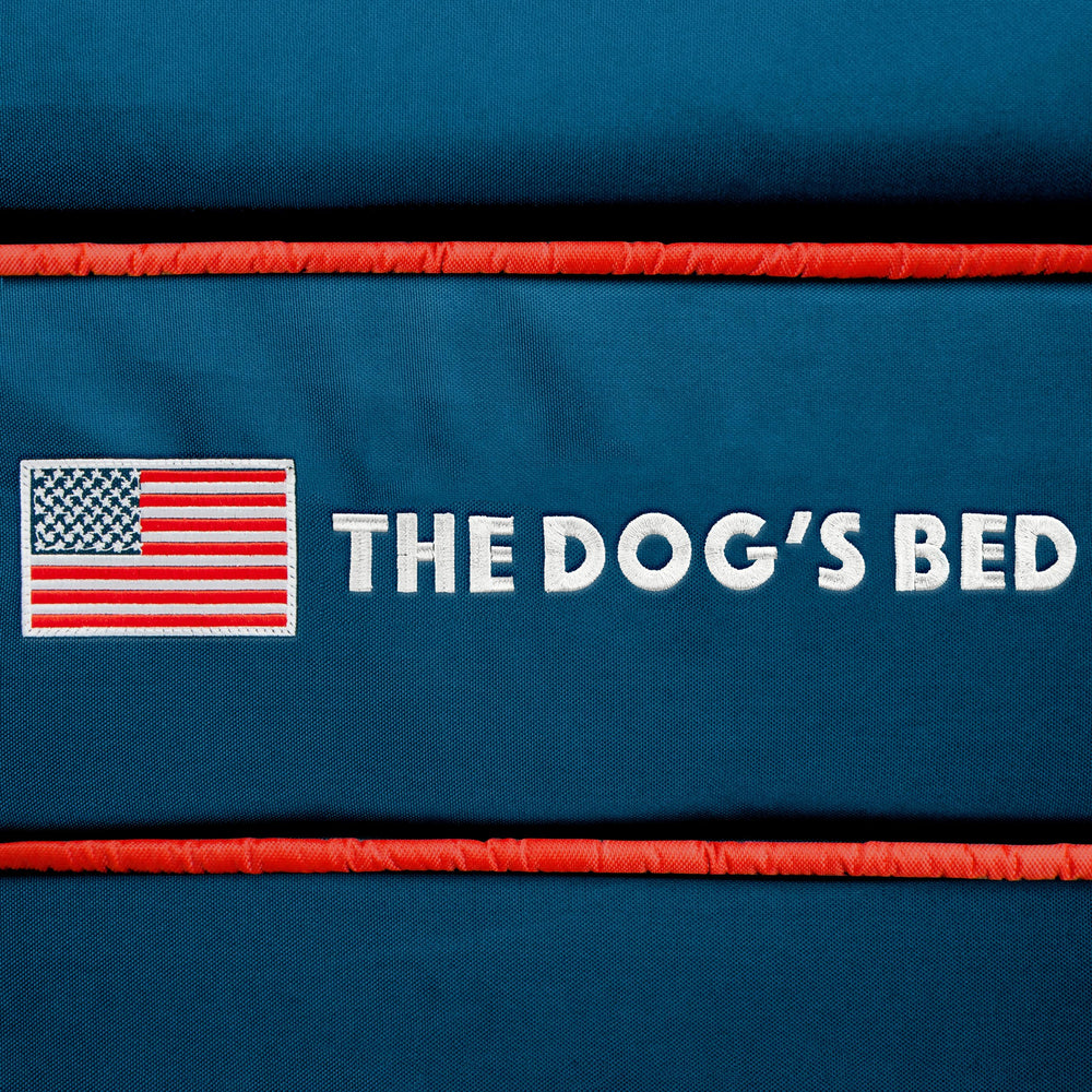 The Dog's Balls dog bed cover blue USA flag on-bed demonstrates integration with a space.