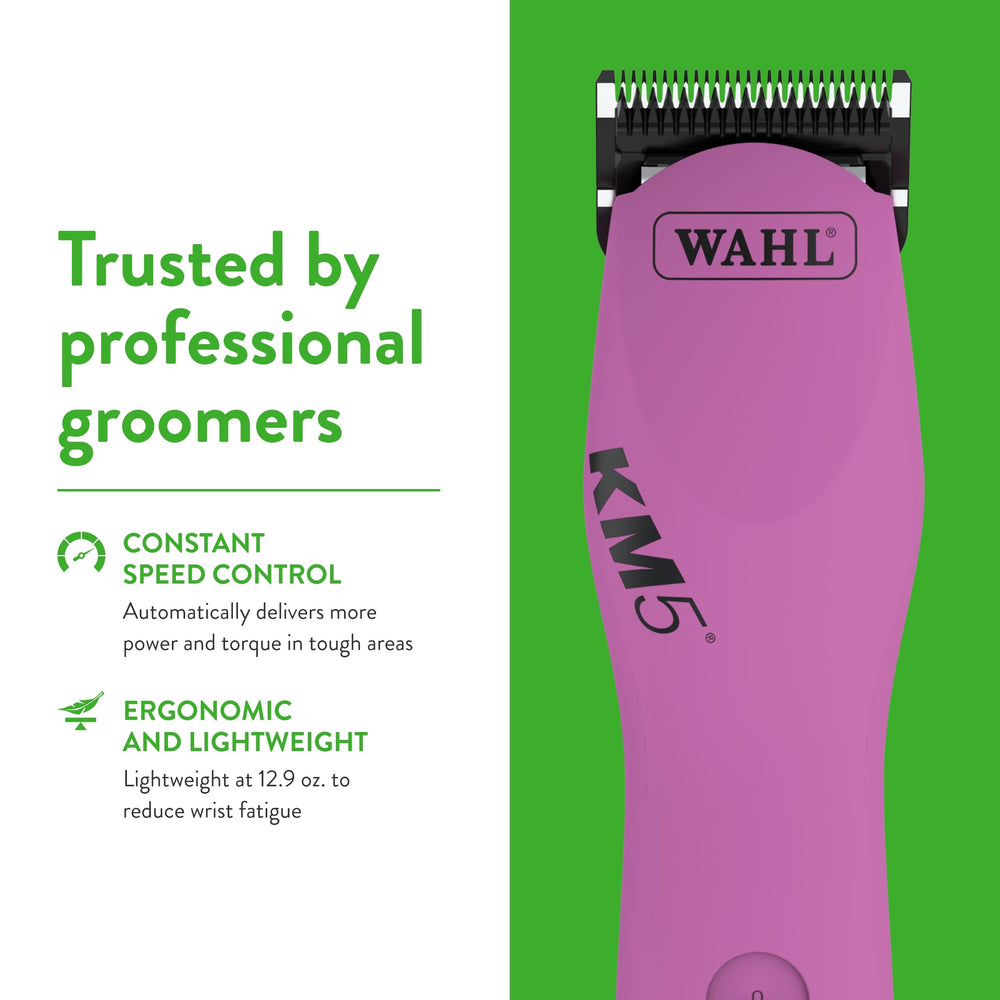 Wahl Pro Animal pink clipper held in hand for precision.