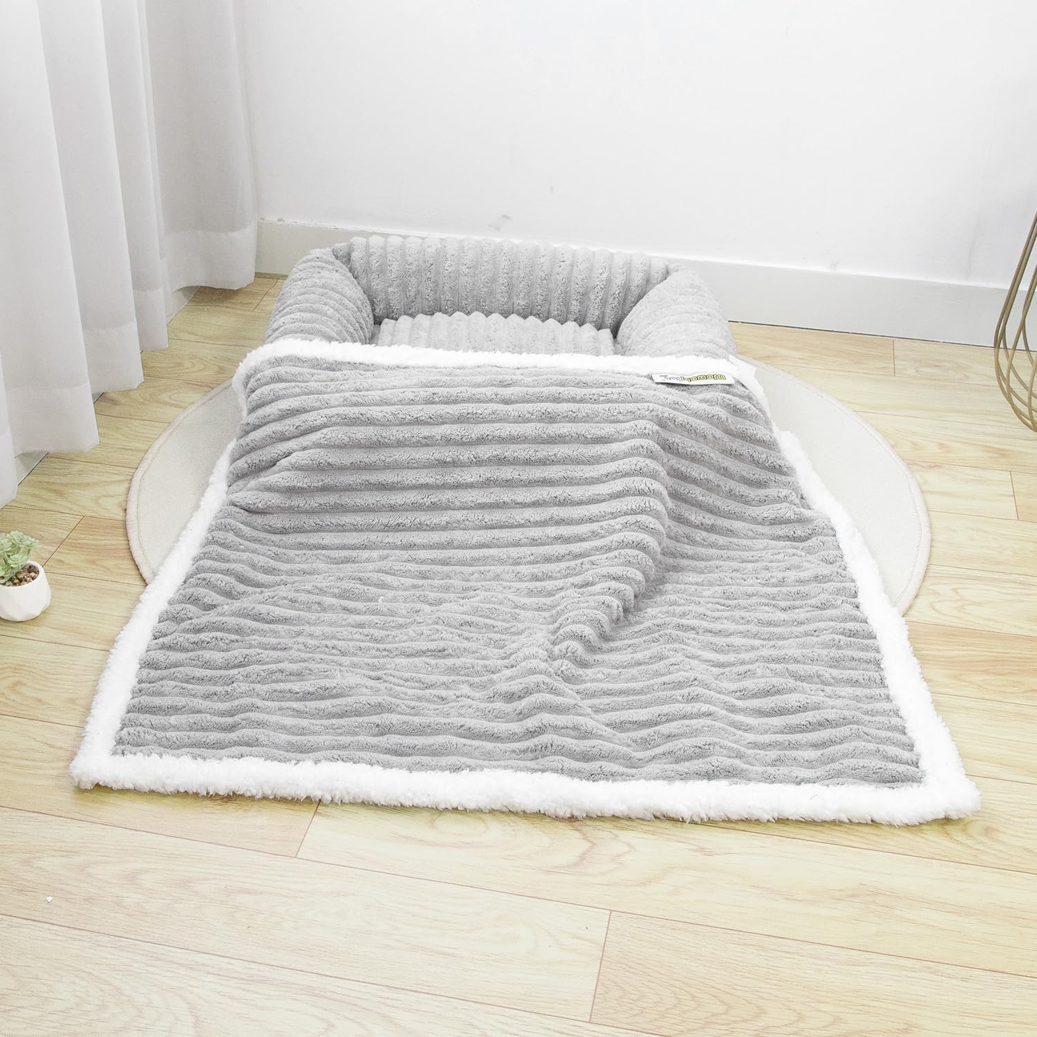 WowOhPet waterproof pet blanket on couch with sherpa for cozy lounging