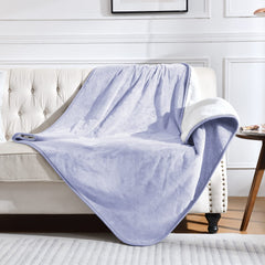 Yaning waterproof blanket on bed and couch in lilac protects furniture from spills.