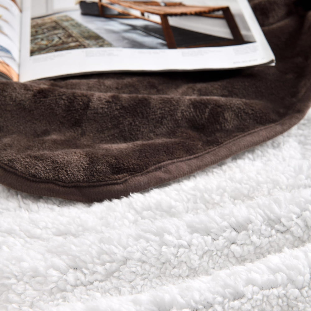 Yaning blanket shows reversible Sherpa and Flannel sides for cozy warmth.